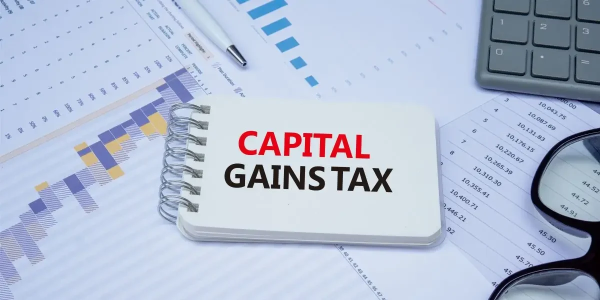 A professional working on the financial records, calculating the capital gains tax on property.