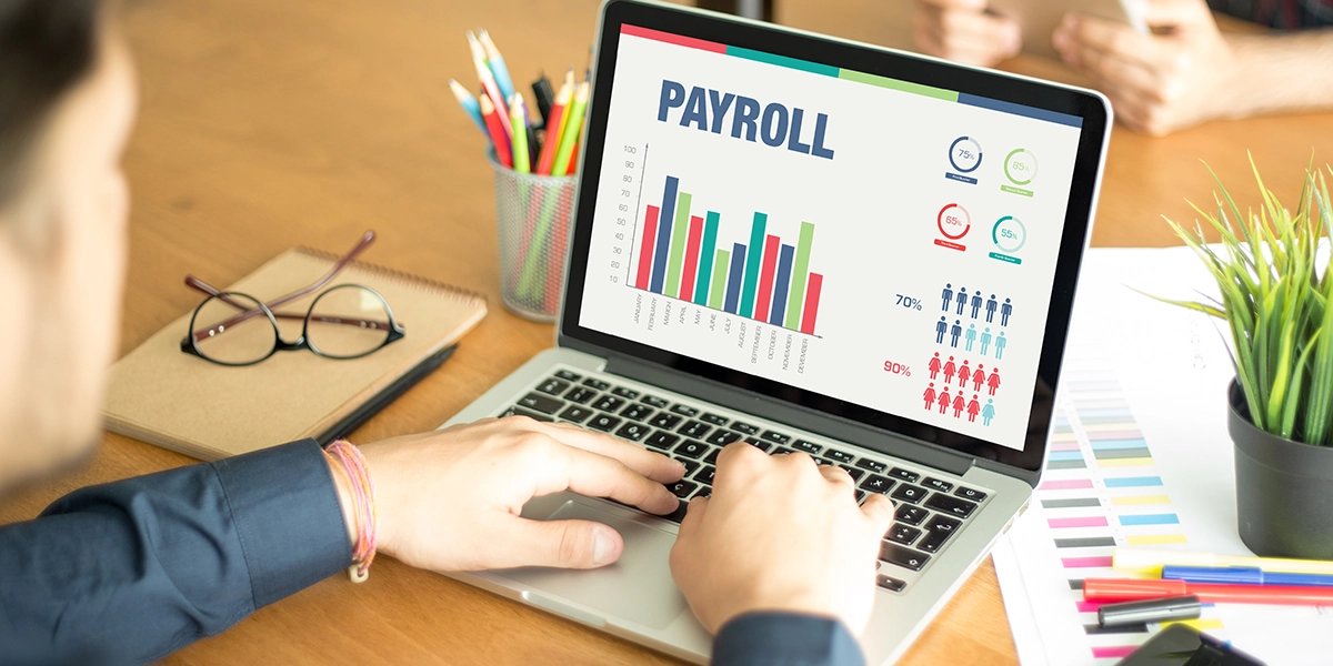 Outsourced payroll calculations shown on screen as a digital solution for managing salaries, reports, and compliance tasks.