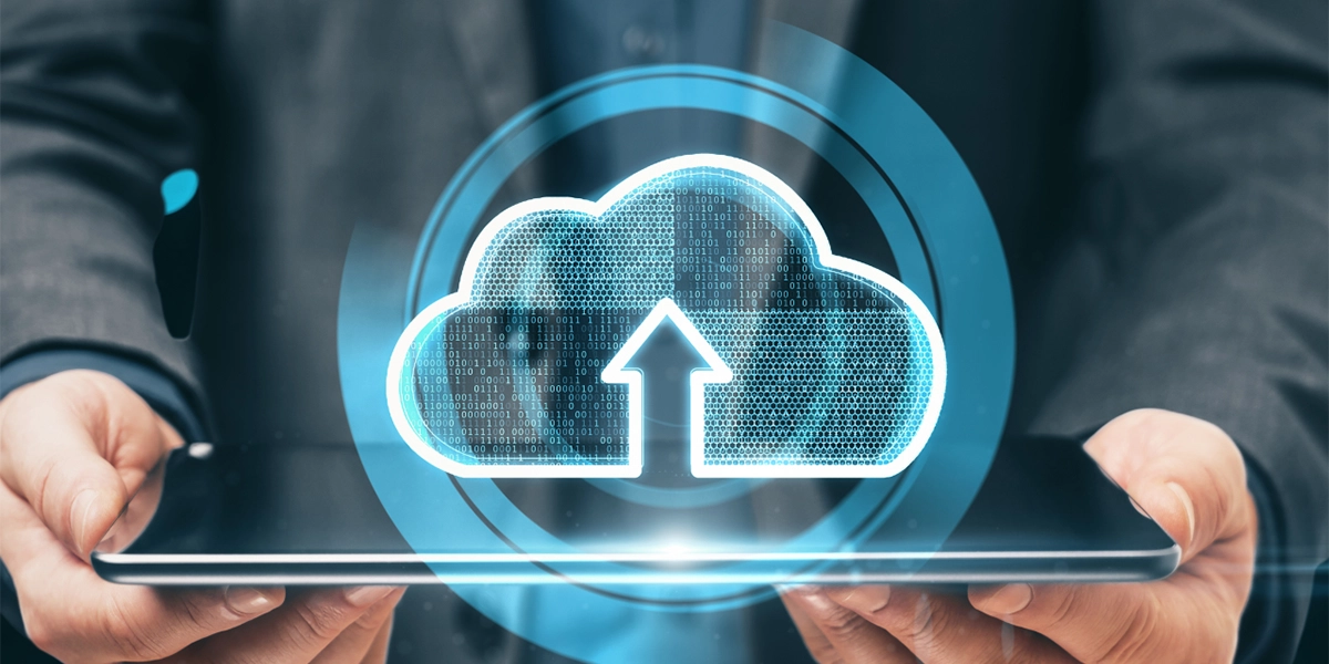 Person holding tablet with digital cloud icon symbolising how cloud platforms boost UK business scalability securely.