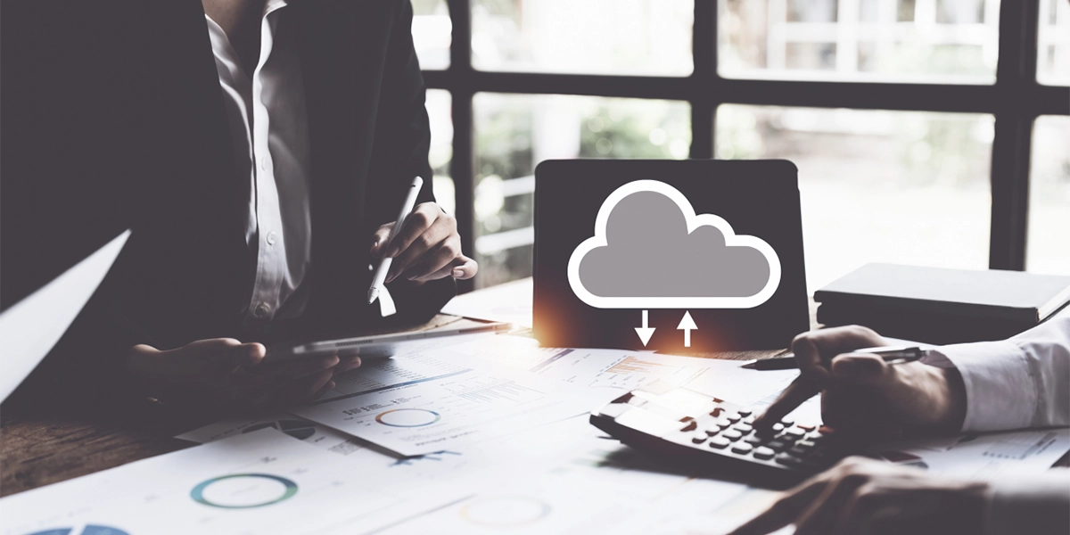 Team working with tablet and calculator symbolising Operational Efficiency through Cloud Accounting in UK businesses.