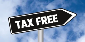 Black directional sign reading “TAX FREE” against a blue sky, symbolising the UK Tax-Free Personal Allowance and income thresholds.